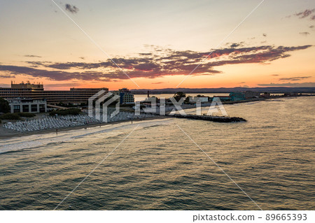 Aerial view of Pomorie city that is located on Black Sea shore. Top view of sand beaches with many hotel buildings and tourist infrastructure. Aerial view of Pomorie city that is located on Black Sea shore. Top view of sand beaches with many hotel buildings and tourist infrastructure. 89665393