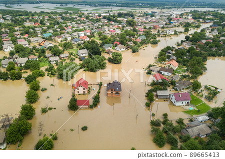 Aerial view of flooded houses with dirty water of Dnister river in Halych town, western Ukraine. Aerial view of flooded houses with dirty water of Dnister river in Halych town, western Ukraine. 89665413