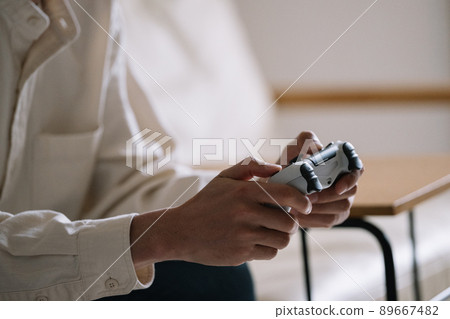 Hands of a man playing a video game 89667482