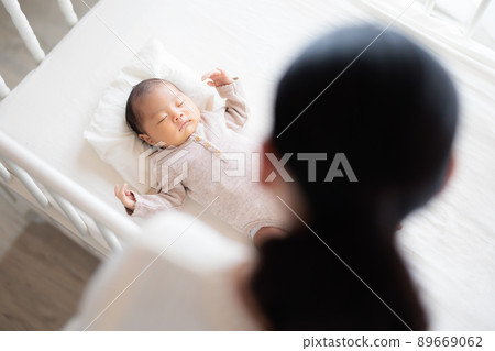 Sleeping baby over a woman Sleeping baby over a woman 89669062