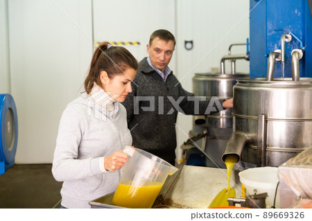 Couple controlling quality of cold pressing olive oil 89669326