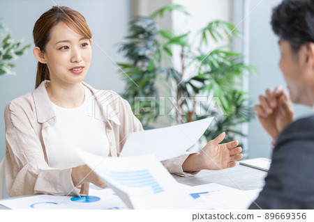 Young business woman speaking at a meeting Young business woman speaking at a meeting 89669356