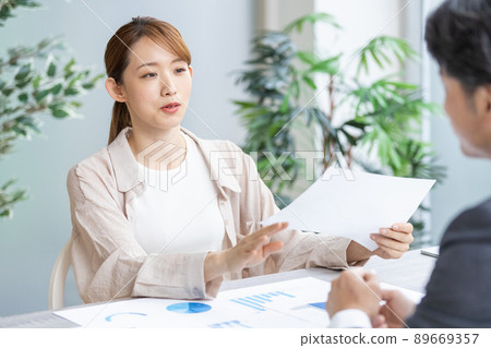 Young business woman speaking at a meeting Young business woman speaking at a meeting 89669357