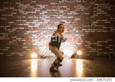 Karate training in the studio. A little girl standing in karate position 89670265