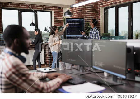 Security system developers analyzing application coding method in order to optimize data processing rate. Mixed race programmers team using machine learning to decypher encrypted stolen files. 89673627