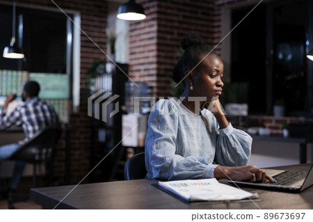 Trading company professional agent sitting in office workspace while using laptop to analyze market charts. Financial advisor at work, reviewing investment documentation while trying to predict trend. 89673697