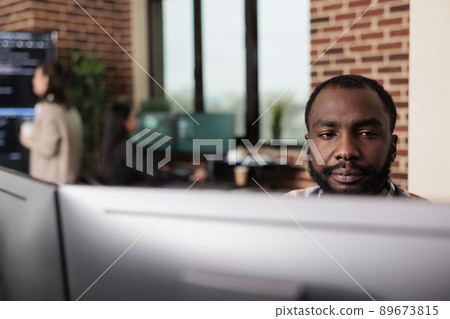 African american programmer developing high security application with multiple layers of scalability. Advanced technology cyber developer creating a node network using binary encryption. 89673815