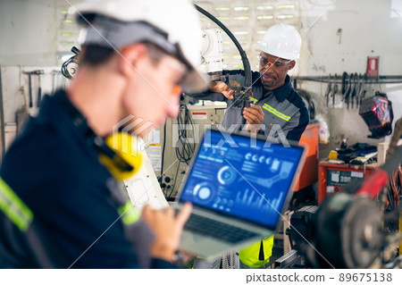 Young factory worker working with adept robotic arm 89675138