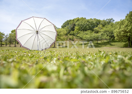 UV protection with lush nature and white parasol 89675652