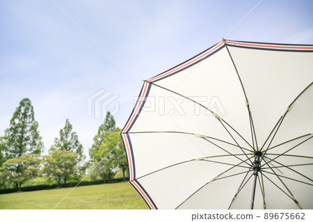 Green nature and white parasol Green nature and white parasol 89675662