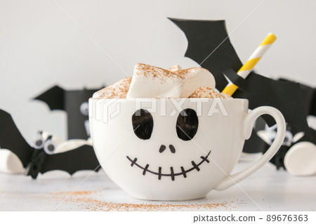 Painted white cup scary jacks face with marshmallows Hot chocolate cacao drink DIY for kids Halloween home activities Holiday art children craft Handmade decorations 89676363