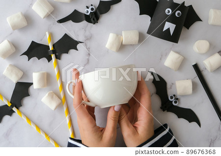 Female hands paint on white cup scary jacks face DIY for kids Halloween home activities Holiday art children craft Handmade decorations Step by step Socially distanced at home Female hands paint on white cup scary jacks face DIY for kids Halloween home activities Holiday art children craft Handmade decorations Step by step Socially distanced at home 89676368