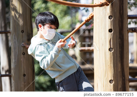 Boy playing well in the park Boy playing well in the park 89677155