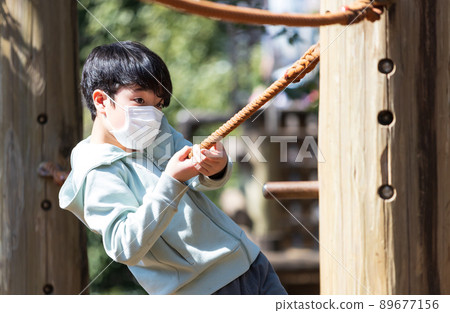 Boy playing well in the park Boy playing well in the park 89677156