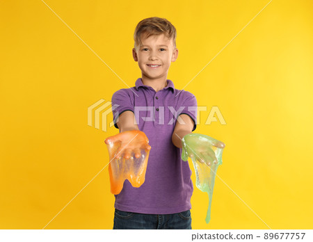 Preteen boy with slime on yellow background 89677757