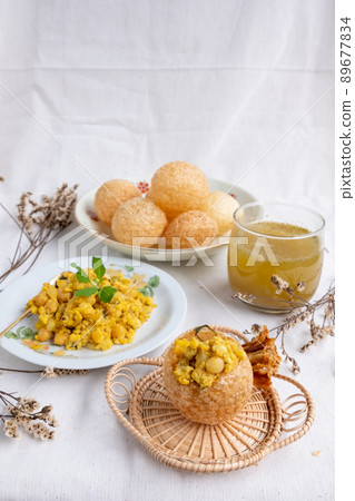 Homemade pani puri, Golgappa Indian snack on cotton calico background Homemade pani puri, Golgappa Indian snack on cotton calico background 89677834