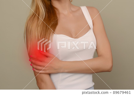 young woman experiencing pain in elbow joint young woman experiencing pain in elbow joint 89679461