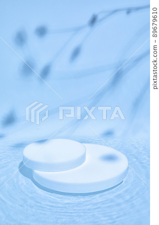 white cylinder podium on blue water with plants shadows white cylinder podium on blue water with plants shadows 89679610