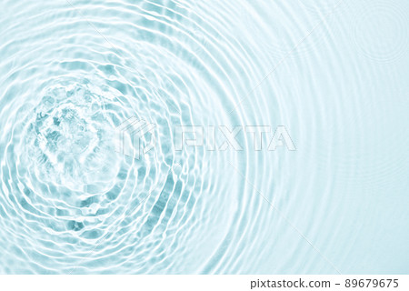 The texture of water on a blue background in bright sunlight. 89679675