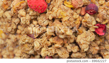Close-up of granola, breakfast dish, snack. On the photo is a granule of oatmeal, honey and berries. 89682227