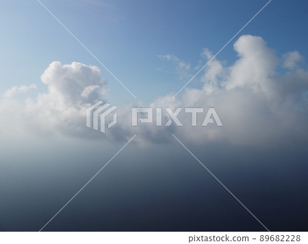 Abstract aerial nature summer ocean sunset sea and sky background. Small waves on clear water surface in motion blur with bokeh lights from sunrise. Holiday, vacation and recreational concept 89682228