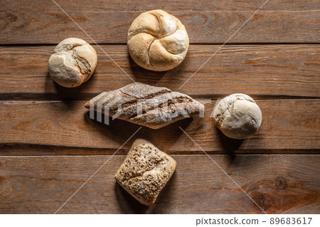 Bread with wheat ears and flour on wood board, top view. 89683617