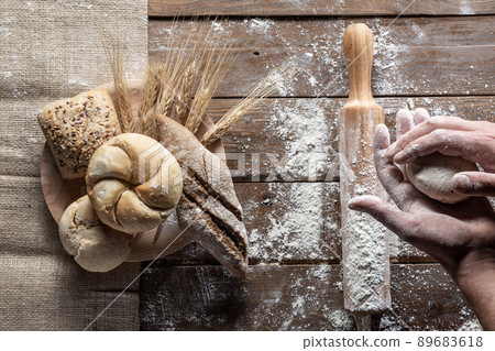 Bread with wheat ears and flour on wood board, top view. 89683618