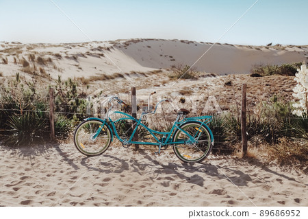 Blue bike standing on dune on the sea coast Blue bike standing on dune on the sea coast 89686952