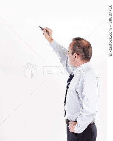 businessman showing a pencil on the copy space businessman showing a pencil on the copy space 89687716