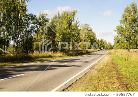 Autumn road on background blue sky Autumn road on background blue sky 89687767