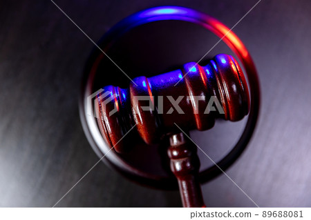 Law theme. Court of law trial in session. Judge gavel on wooden table with police emergency services light. Mallet of judge on dark background. Justice human rights concept. Copy space 89688081