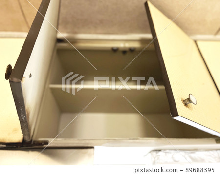 In an empty hanging cupboard in an old kitchen In an empty hanging cupboard in an old kitchen 89688395