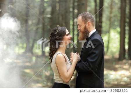 bride and groom standing in the woods.photo with cloud effect 89688531