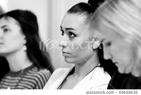 listeners take notes in notebooks,sitting in the conference room listeners take notes in notebooks,sitting in the conference room 89688636
