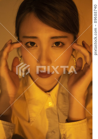 Orange light female looking at the camera 89688740