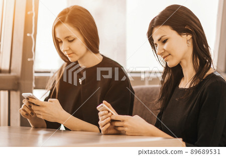 Employees of the company with smartphones in the workplace in th 89689531