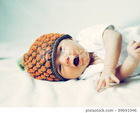 cute newborn baby in knitted hat lying 89691046