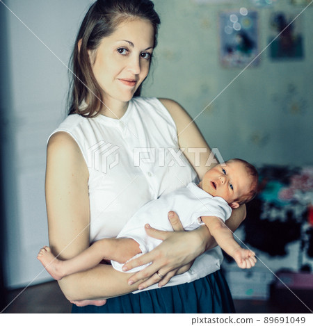 concept of motherhood:a portrait of a young mother with a newbor 89691049