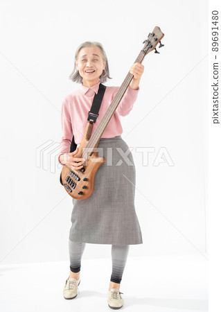Female senior playing the base Female senior playing the base 89691480