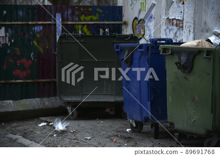 Garbage containers and bags with garbage on the street 89691768