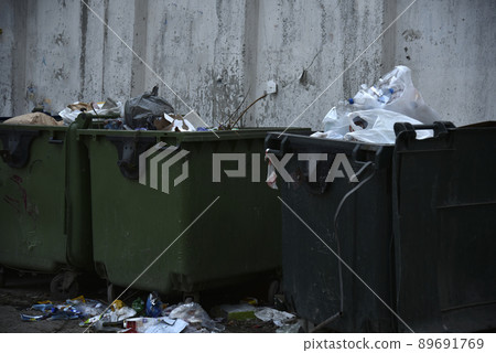 Garbage containers and bags with garbage on the street 89691769