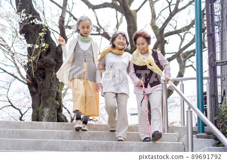 Senior woman descending stairs 89691792