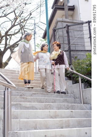 Senior woman descending stairs Senior woman descending stairs 89691795
