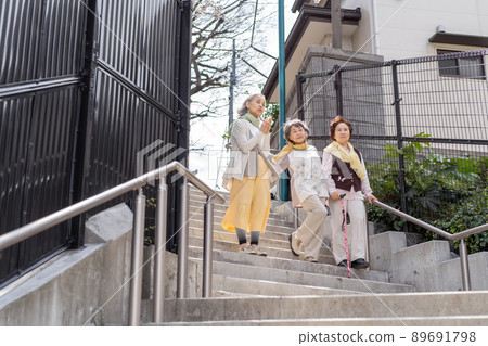 Senior woman descending stairs Senior woman descending stairs 89691798