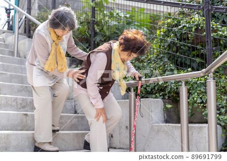 Senior woman descending stairs 89691799