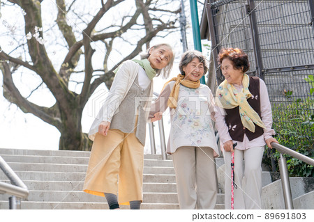 Senior woman descending stairs 89691803