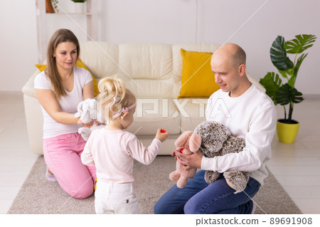 Happy child girl with cochlear implant having fun with her family - hearing aid for deaf and innovative health technology concept 89691908