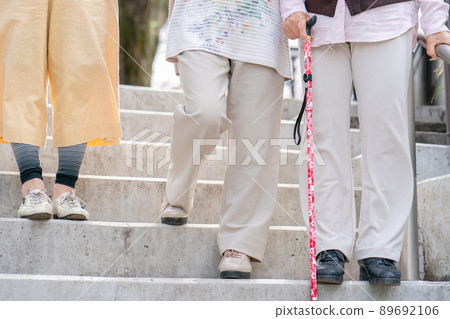 Senior woman going down the stairs 89692106