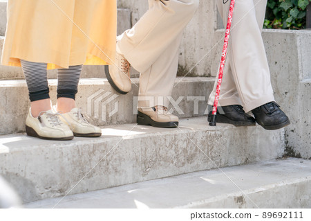 Senior woman going down the stairs 89692111