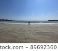 A girl standing on a sandy beach in the spring sea 89692360
